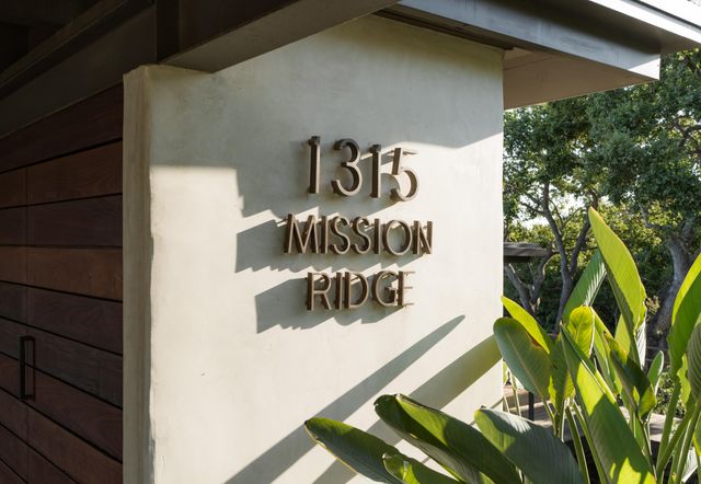 a sign on a wall next to a building