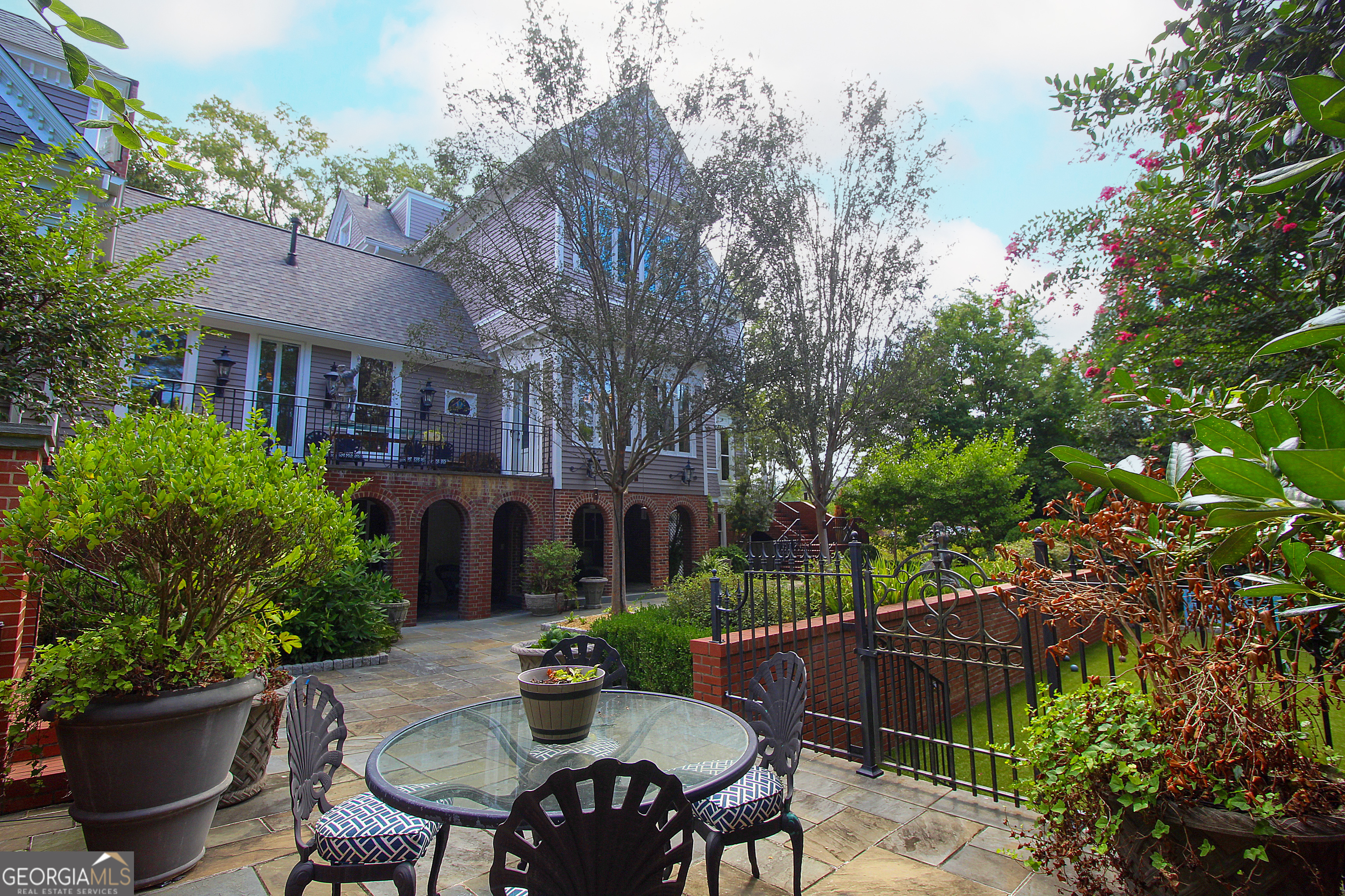 320 East 3rd Avenue Rome, GA 30161 - Photo 130 of 152 a view of a patio with table and chairs potted plants and large tree