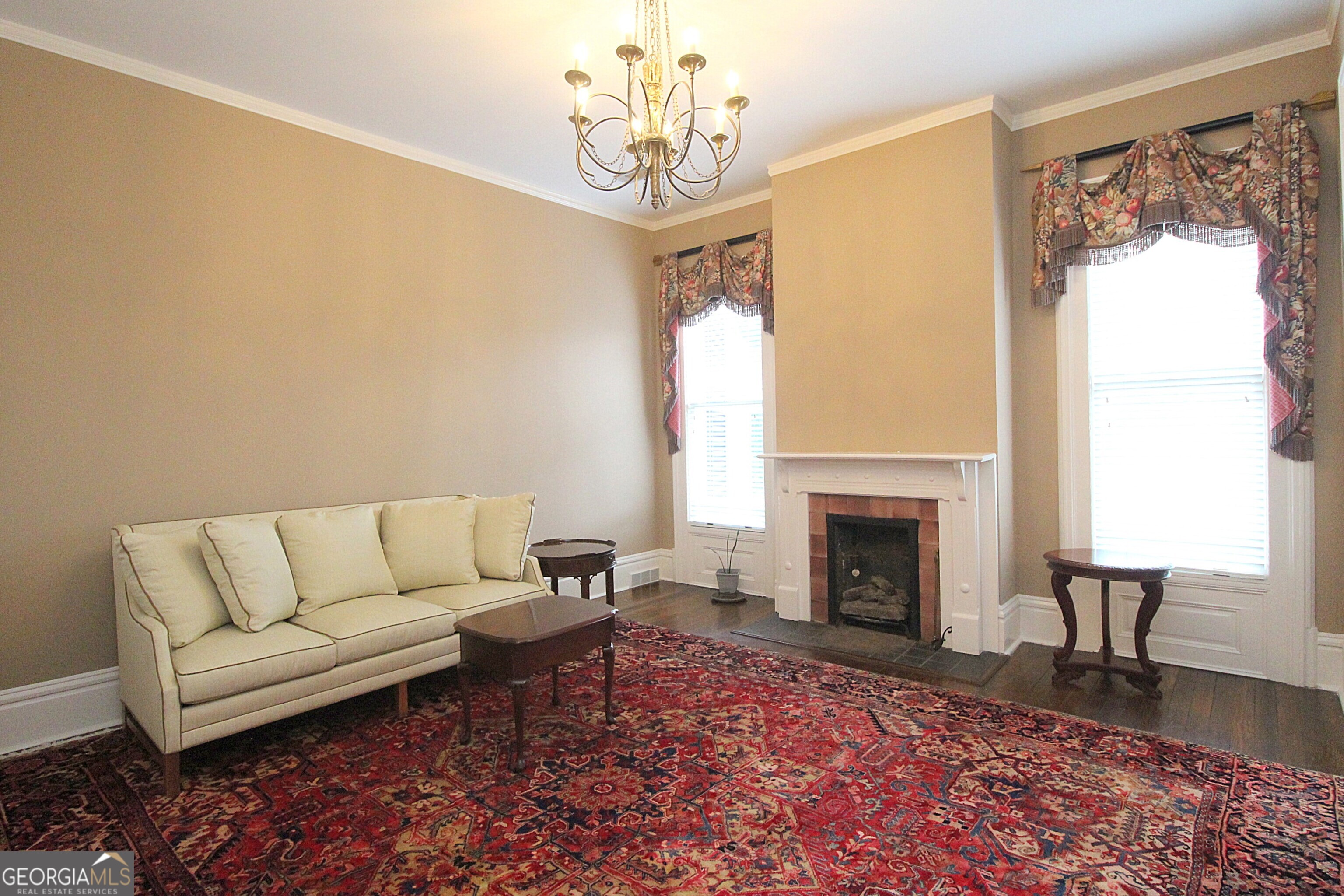 320 East 3rd Avenue Rome, GA 30161 - Photo 69 of 152 a living room with furniture a fireplace and a chandelier
