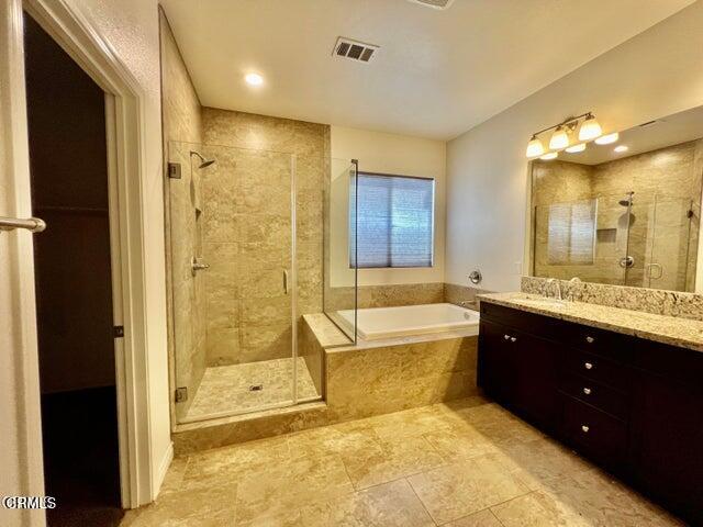 668 Owens River Drive Oxnard, CA 93036 - Photo 8 of 10 a bathroom with a granite countertop tub sink shower and mirror