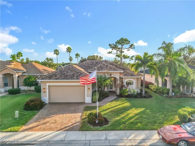 a front view of a house with a yard and a garage