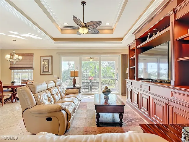 a living room with furniture ceiling fan and a rug
