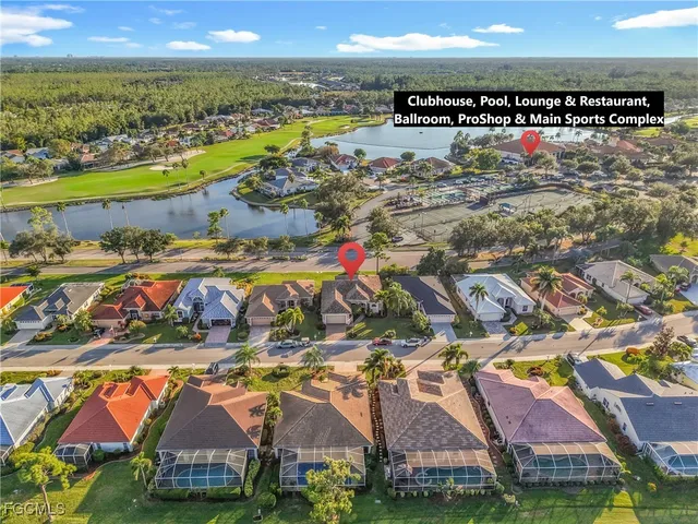 an aerial view of residential houses with outdoor space and ocean