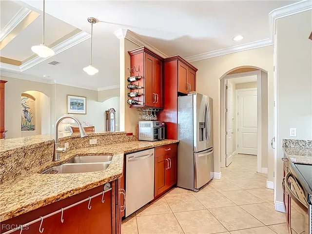 a kitchen with stainless steel appliances granite countertop a refrigerator and a stove top oven