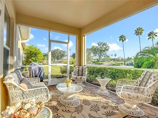 a living room with patio furniture and garden