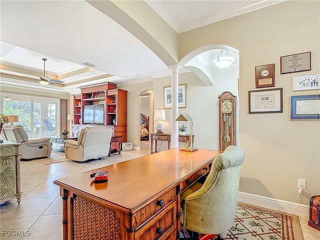 a living room with furniture pool table and a large window