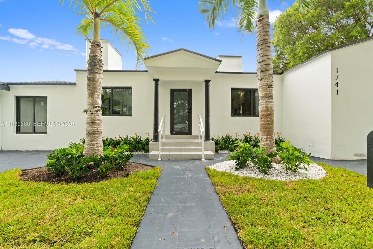 1741 Southwest 17th Court Miami, FL 33145 - Photo 1 of 19 a front view of a house with garden