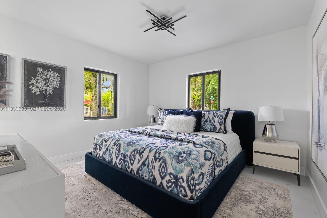 1741 Southwest 17th Court Miami, FL 33145 - Photo 12 of 19 a bedroom with a bed lamps and window