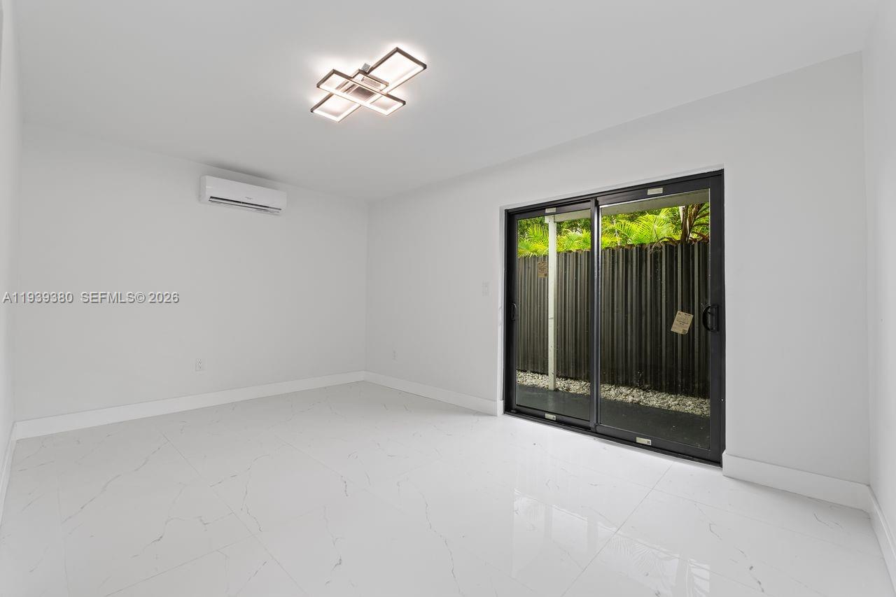 1741 Southwest 17th Court Miami, FL 33145 - Photo 18 of 19 a view of an empty room with a window