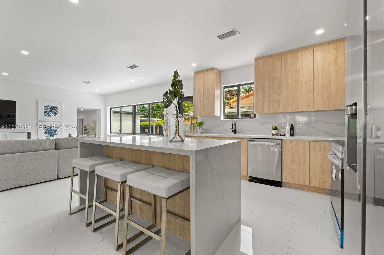 1741 Southwest 17th Court Miami, FL 33145 - Photo 8 of 19 a kitchen with granite countertop sink window and chairs