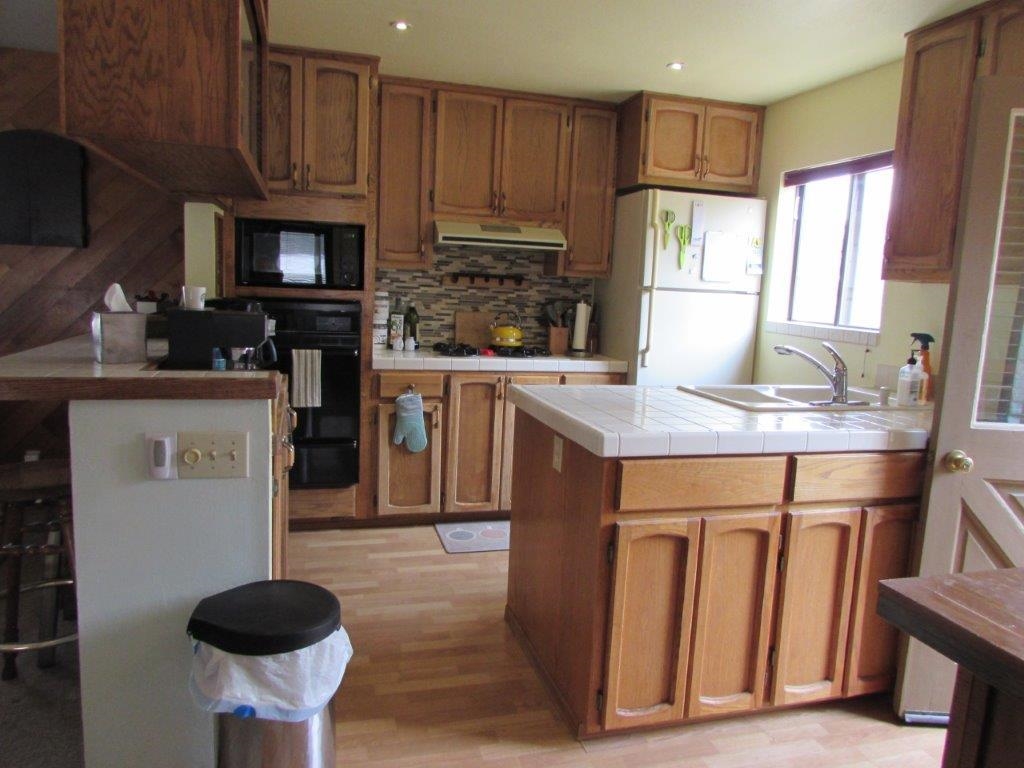 154 South Landing Road Crowley Lake, CA 93546 - Photo 7 of 27 a kitchen with granite countertop a sink a counter space cabinets and appliances