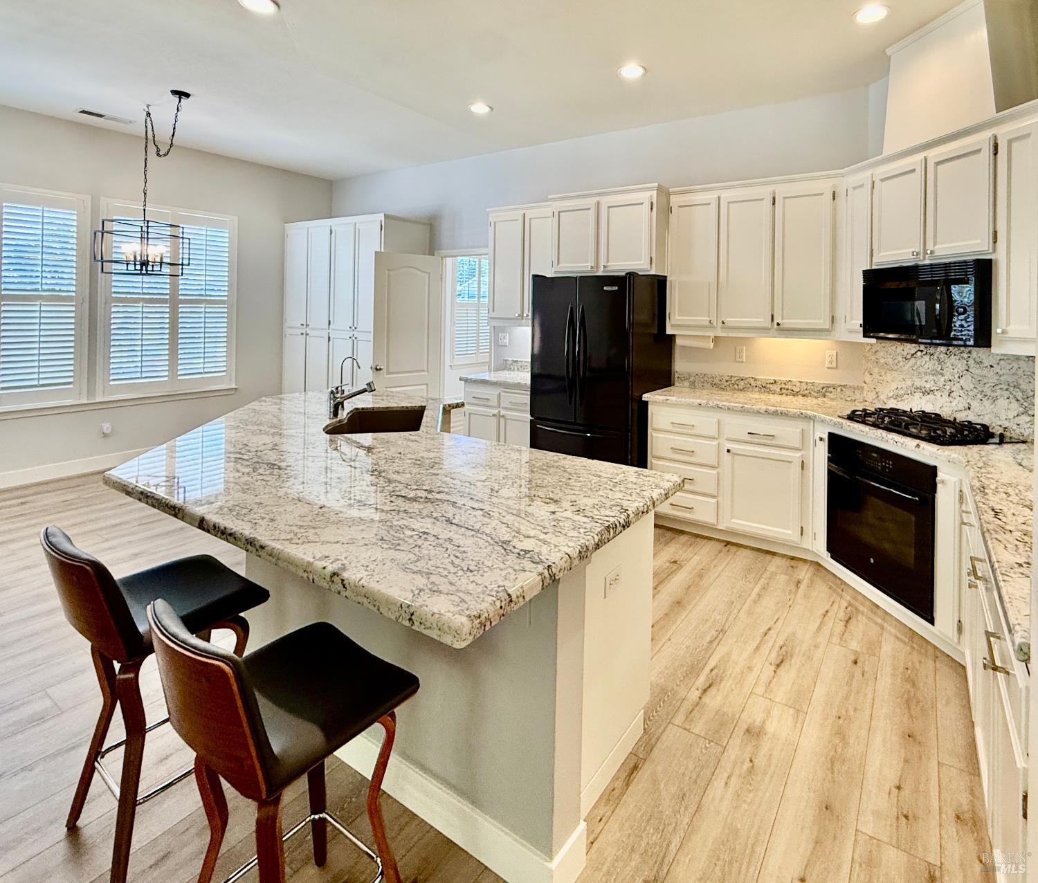 844 Signorelli Circle St. Helena, CA 94574 - Photo 11 of 32 a kitchen with stainless steel appliances kitchen island granite countertop a kitchen island a stove a table and chairs