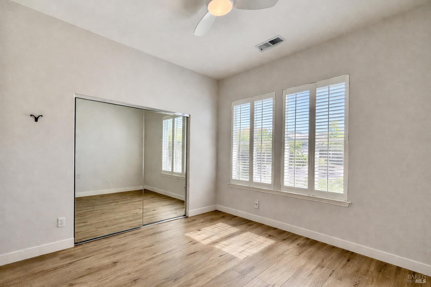 844 Signorelli Circle St. Helena, CA 94574 - Photo 15 of 32 an empty room with wooden floor and windows