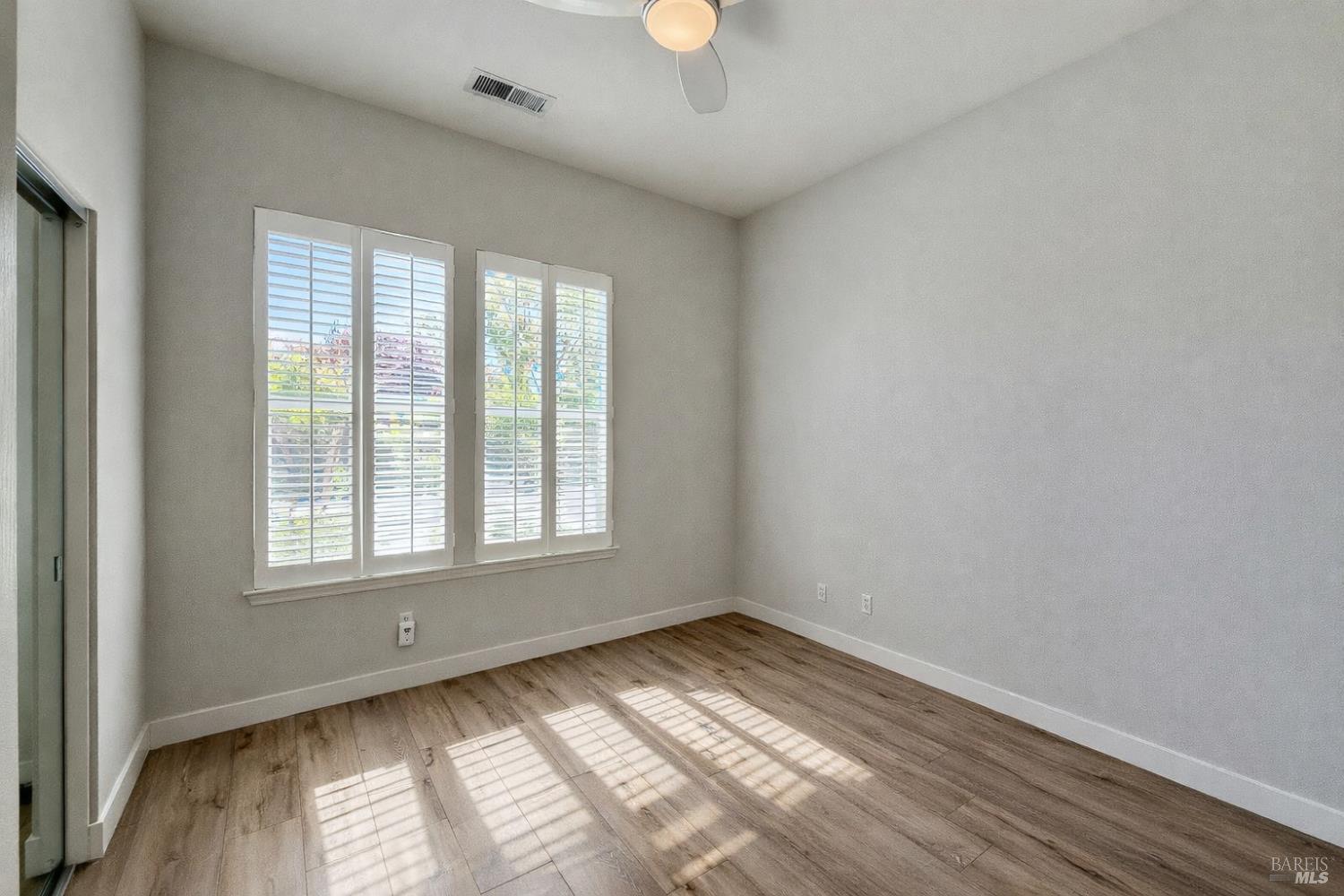 844 Signorelli Circle St. Helena, CA 94574 - Photo 16 of 32 a view of an empty room with wooden floor and a window