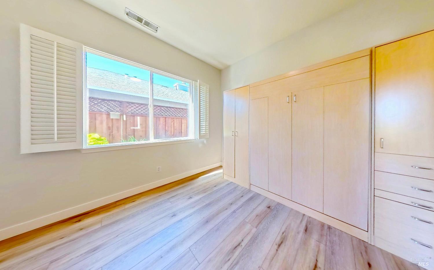 844 Signorelli Circle St. Helena, CA 94574 - Photo 17 of 32 a view of an empty room with wooden floor and a window