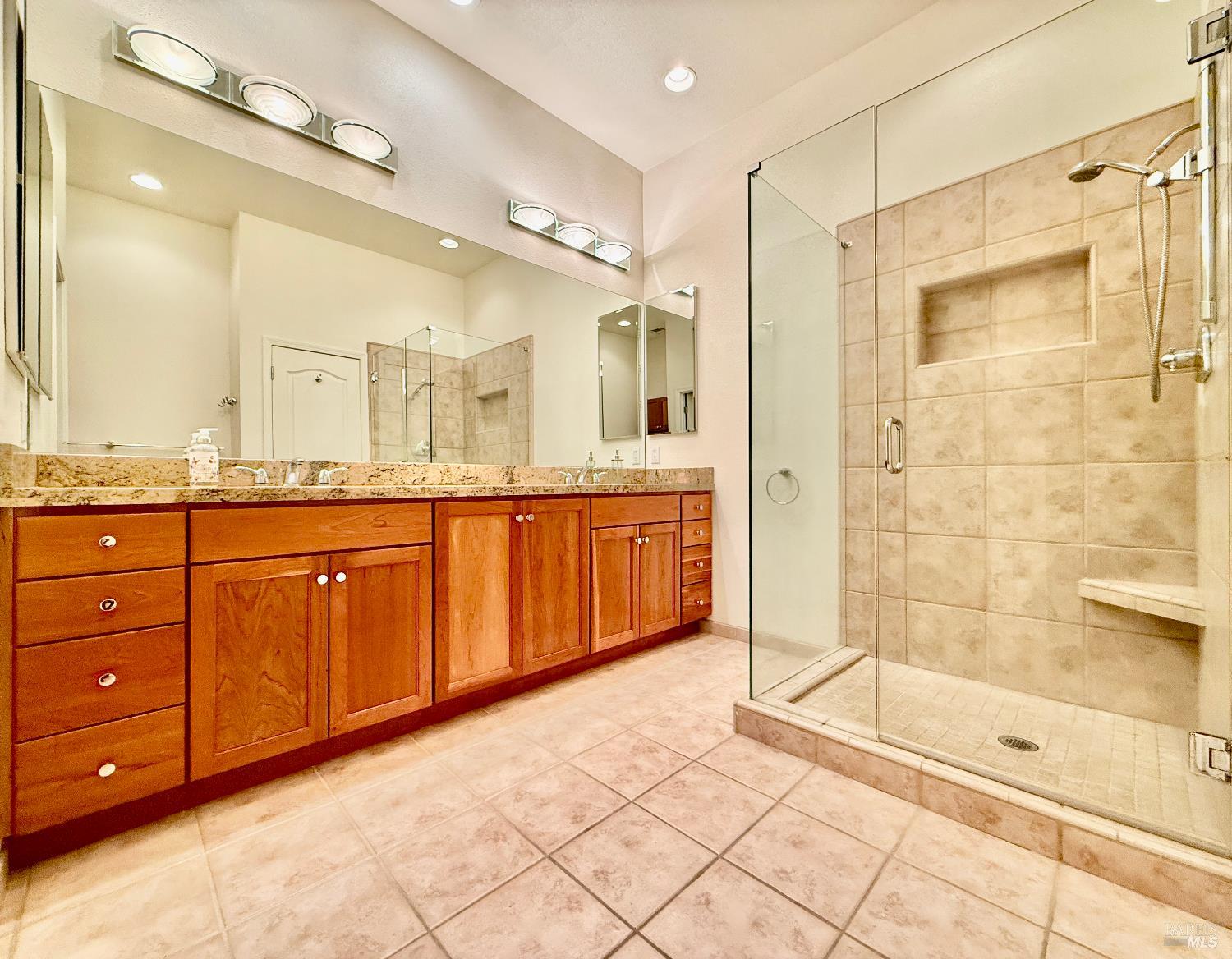 844 Signorelli Circle St. Helena, CA 94574 - Photo 24 of 32 a bathroom with a granite countertop sink mirror and shower