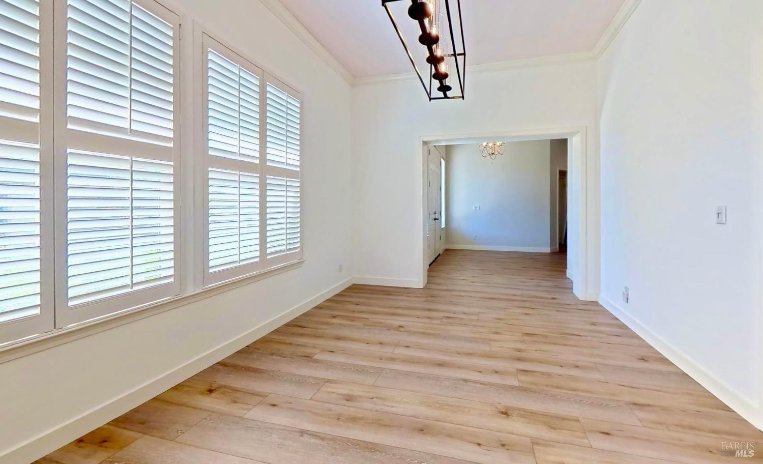 844 Signorelli Circle St. Helena, CA 94574 - Photo 3 of 32 a view of an empty room with wooden floor and a window
