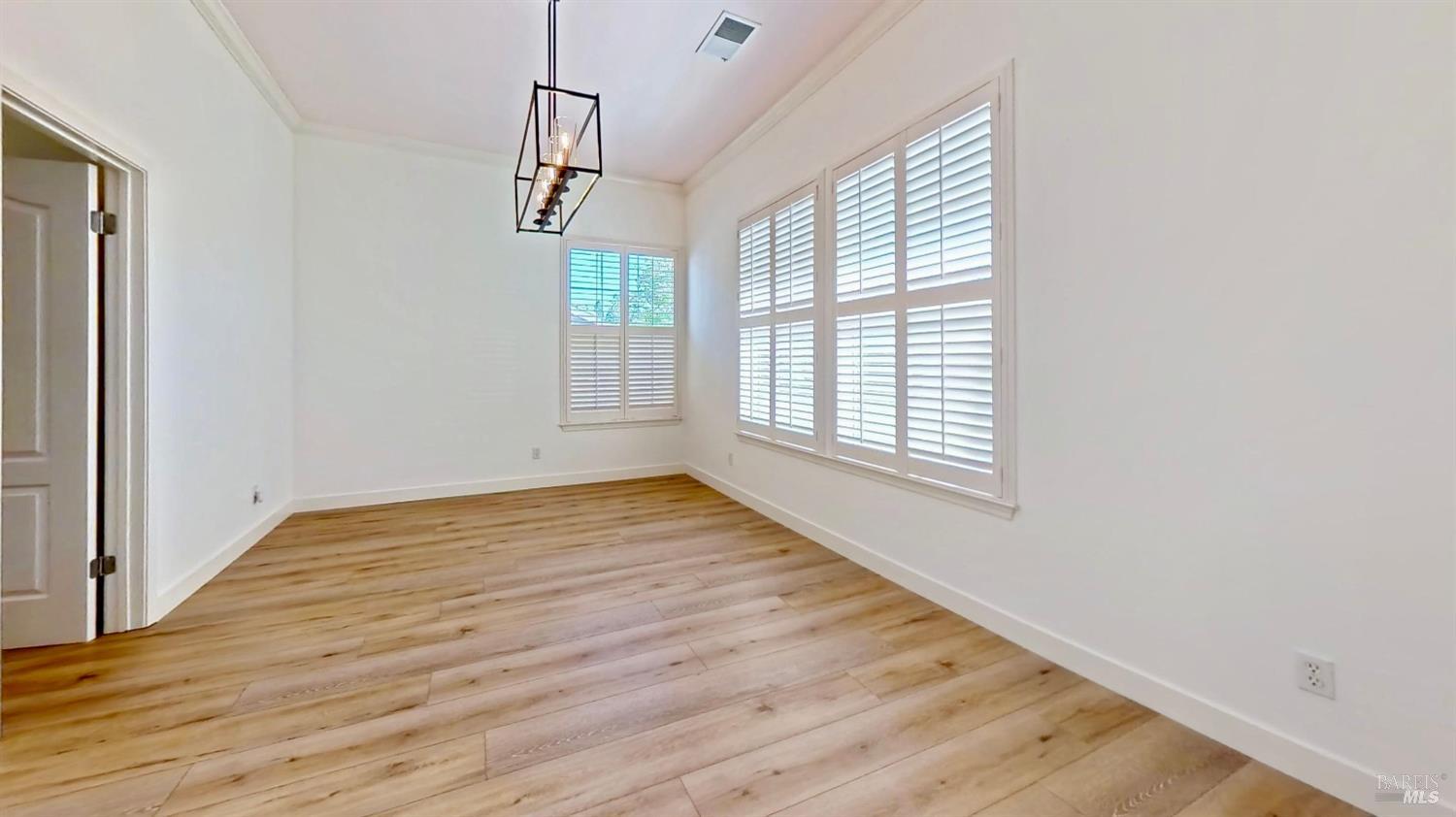 844 Signorelli Circle St. Helena, CA 94574 - Photo 5 of 32 an empty room with wooden floor and windows