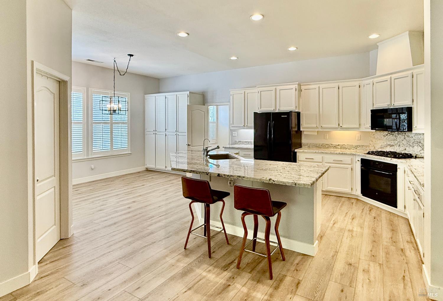 844 Signorelli Circle St. Helena, CA 94574 - Photo 6 of 32 a kitchen with a table chairs refrigerator and microwave