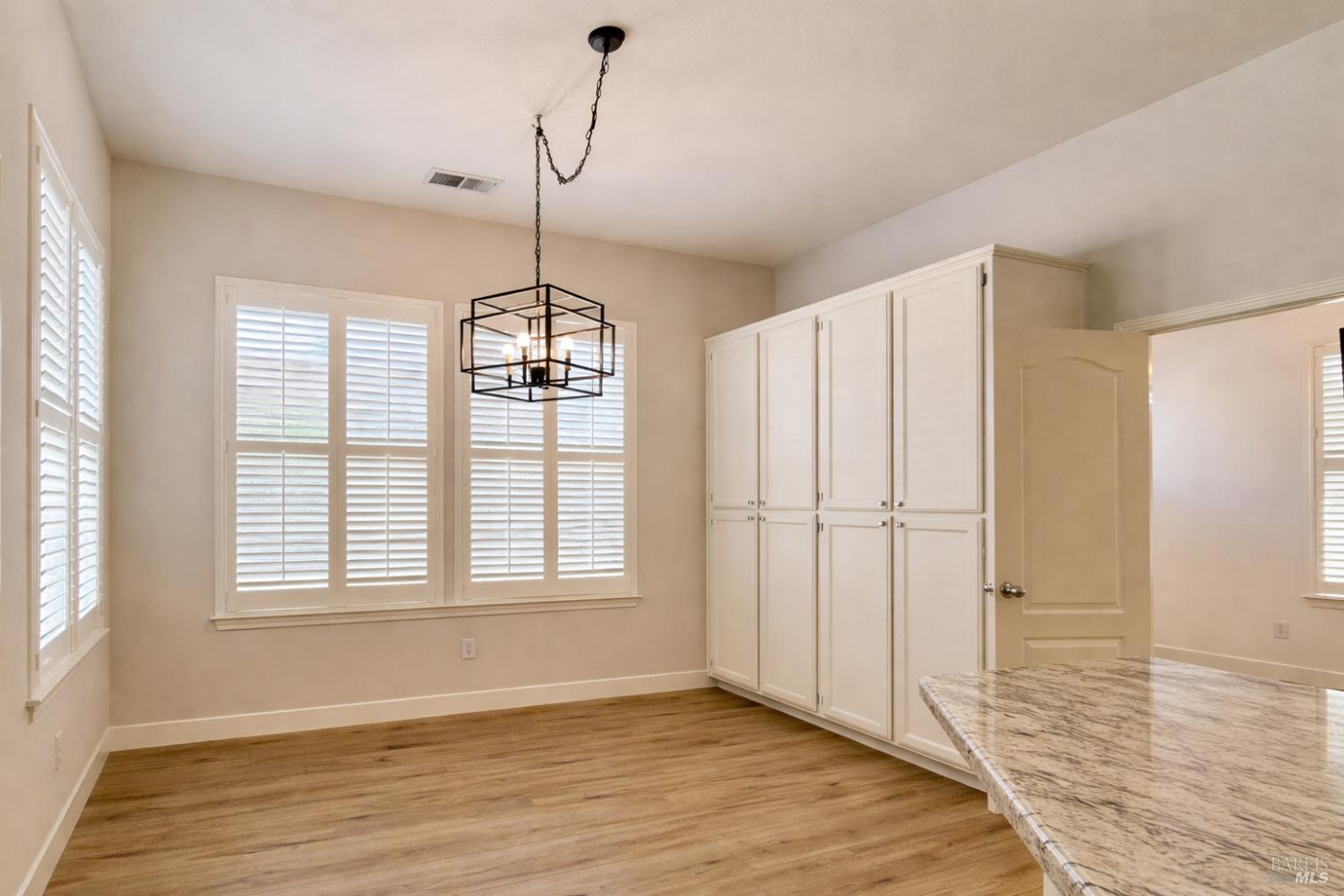 844 Signorelli Circle St. Helena, CA 94574 - Photo 10 of 32 a view of an empty room with wooden floor and a window