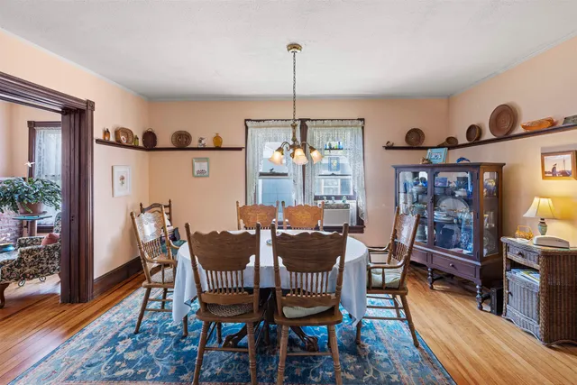 a dining room with furniture window and wooden floor