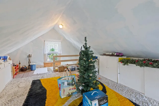 a view of an entryway with wooden floor and a livingroom