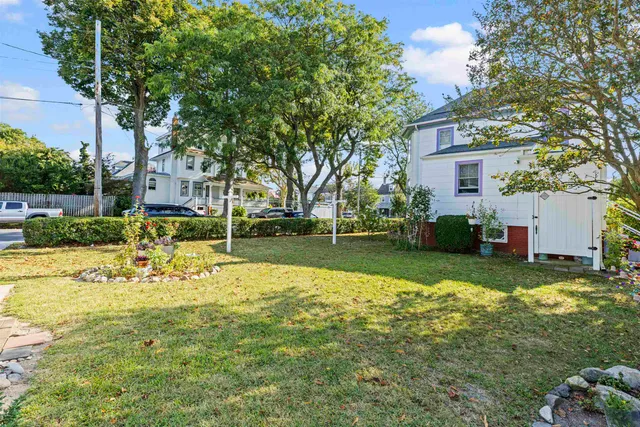 an aerial view of a house with a yard and swimming pool
