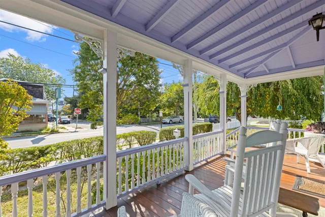 a view of a porch with furniture and backyard