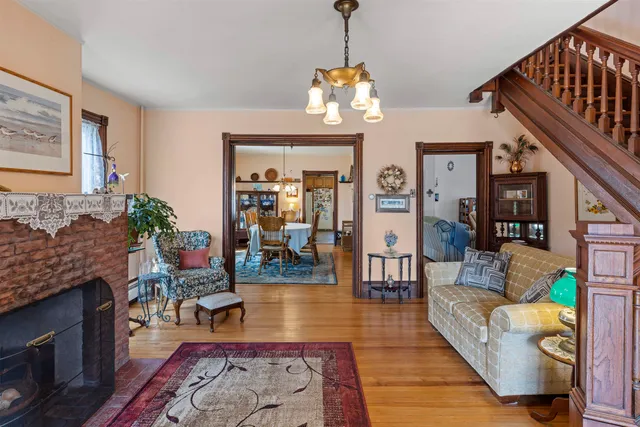 a living room with fireplace furniture and a wooden floor
