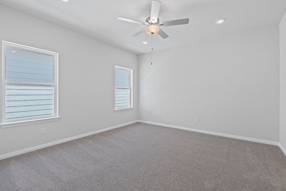 376 Blue Oasis Lane Leander, TX 78641 - Photo 15 of 27 an empty room with windows and fan