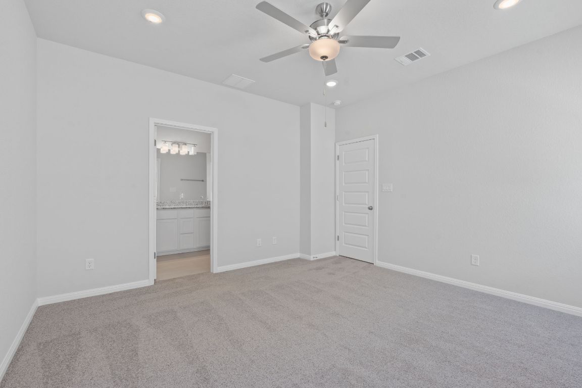 376 Blue Oasis Lane Leander, TX 78641 - Photo 16 of 27 an empty room with a ceiling fan and a window