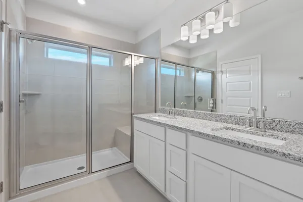 a bathroom with a granite countertop sink mirror and double