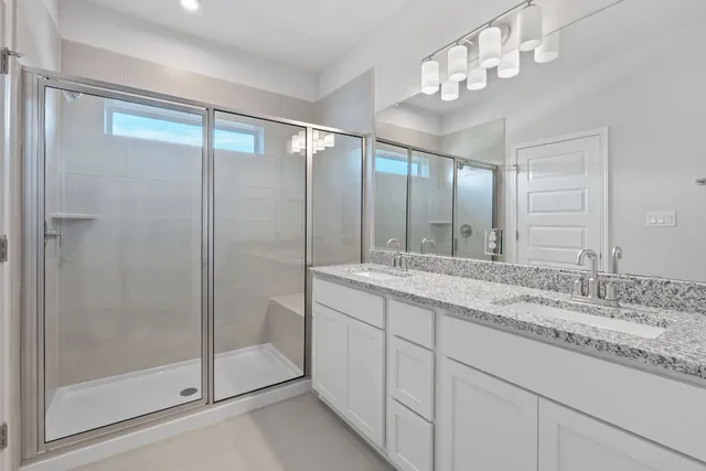 a bathroom with a granite countertop sink mirror and double