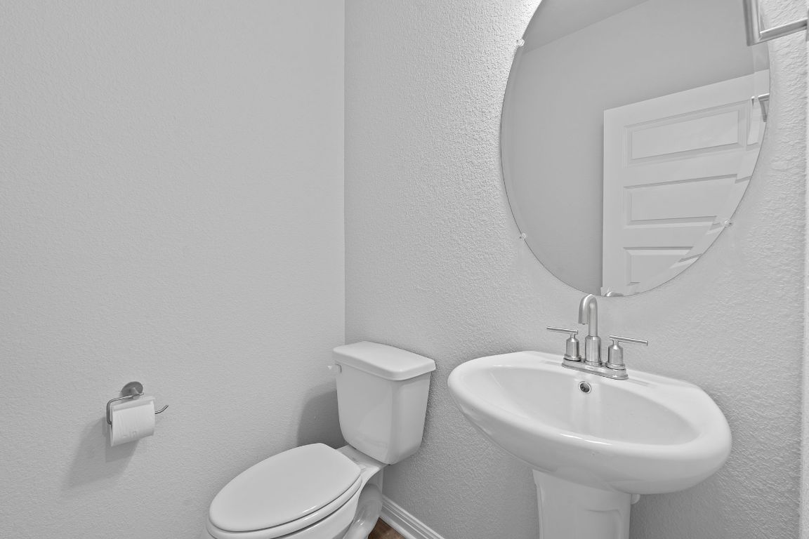 376 Blue Oasis Lane Leander, TX 78641 - Photo 26 of 27 a white toilet sitting next to a white sink