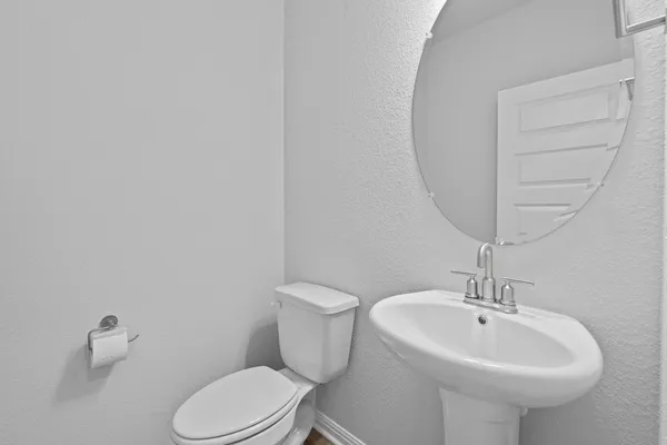 a white toilet sitting next to a white sink
