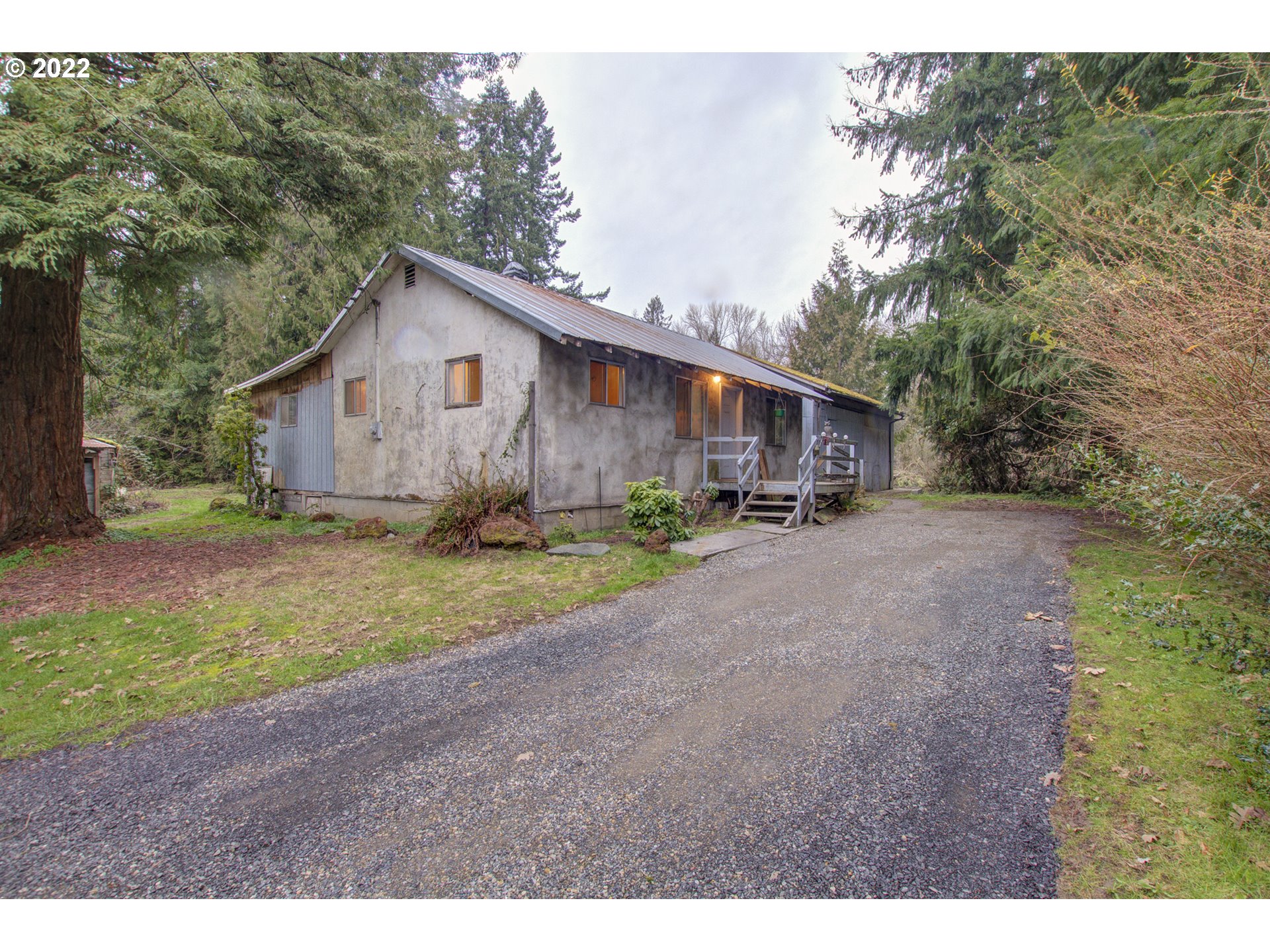 24300 Northwest Maplecrest Road Ridgefield, WA 98642 - Photo 1 of 32 a view of a house with a yard and large trees