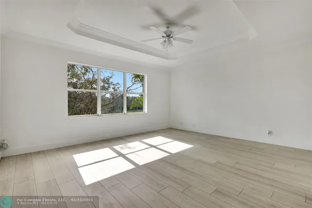 a bathroom with a granite countertop toilet sink and mirror
