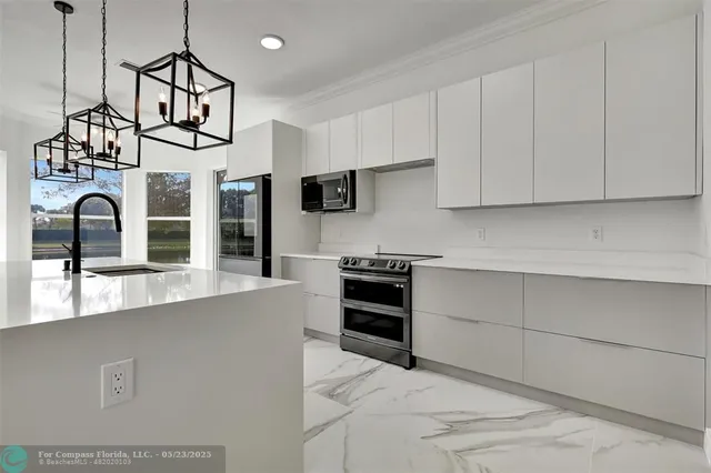 a kitchen with stainless steel appliances granite countertop a stove and a sink