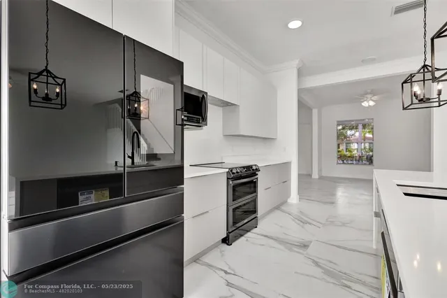 a kitchen with granite countertop a stove and a refrigerator