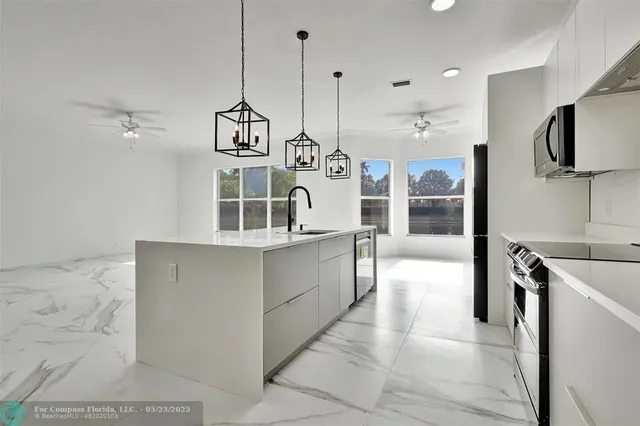 a view of a kitchen with furniture and a chandelier