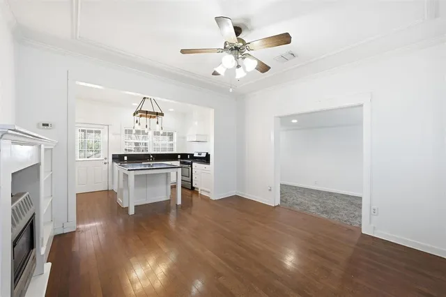 a view of kitchen with sink and refrigerator