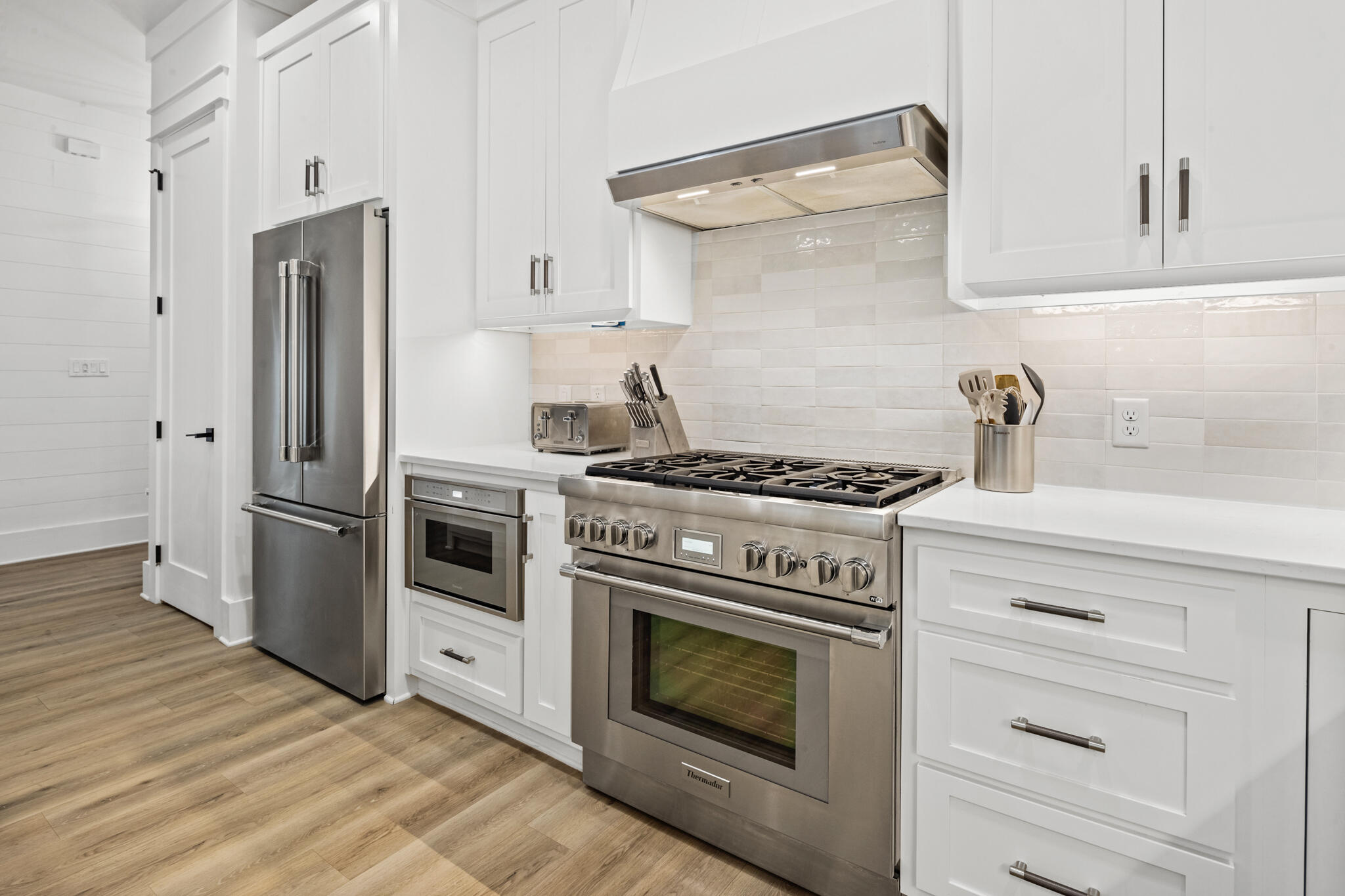 70 Trigger Trail East Inlet Beach, FL 32461 - Photo 12 of 67 a kitchen with stainless steel appliances white cabinets white stove a sink and dishwasher