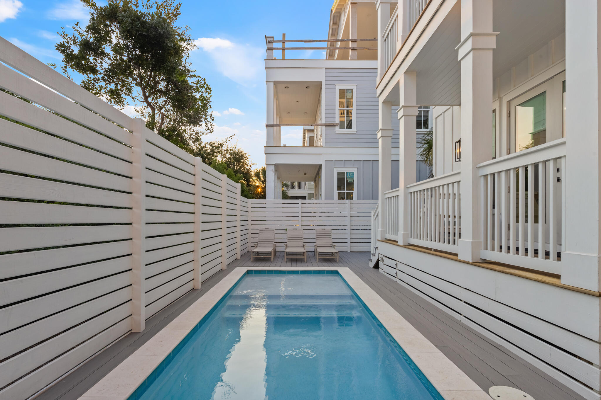 70 Trigger Trail East Inlet Beach, FL 32461 - Photo 62 of 67 a view of a balcony with wooden floor and fence and a floor to ceiling window