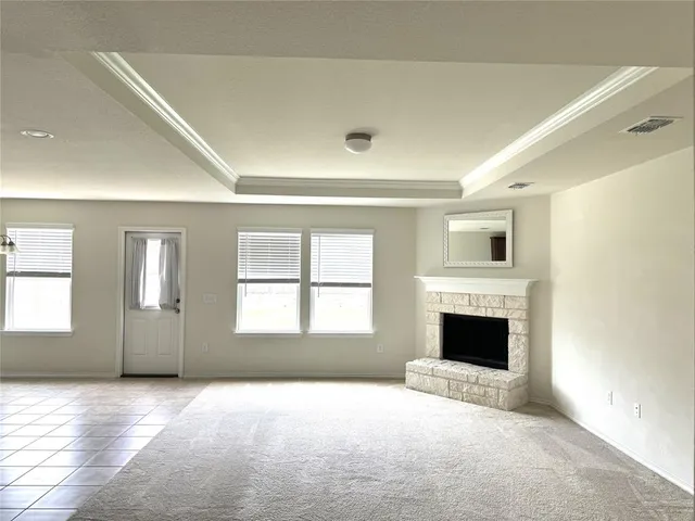 a view of empty room with a fireplace