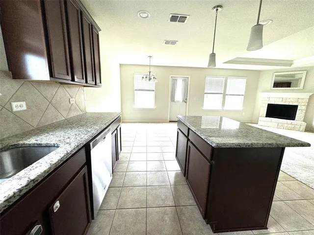 a kitchen with stainless steel appliances granite countertop a sink counter space and a window