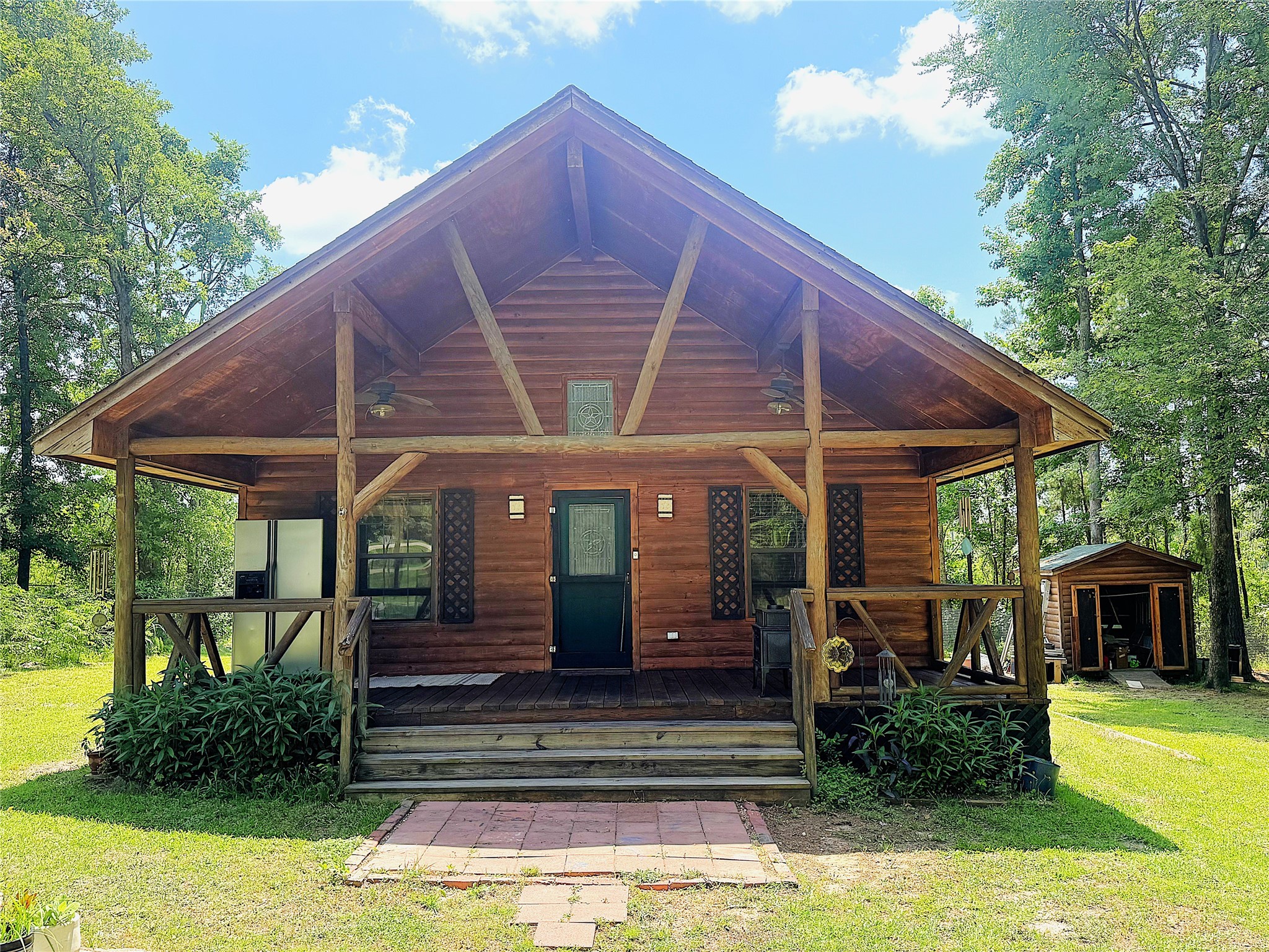 a view of a patio with table and chairs under an umbrella