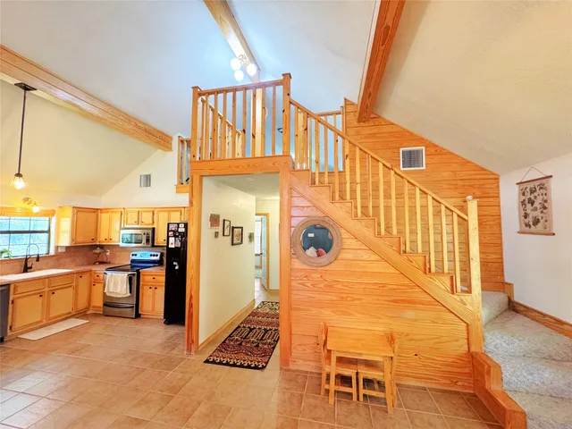 a kitchen with stainless steel appliances a stove sink and microwave