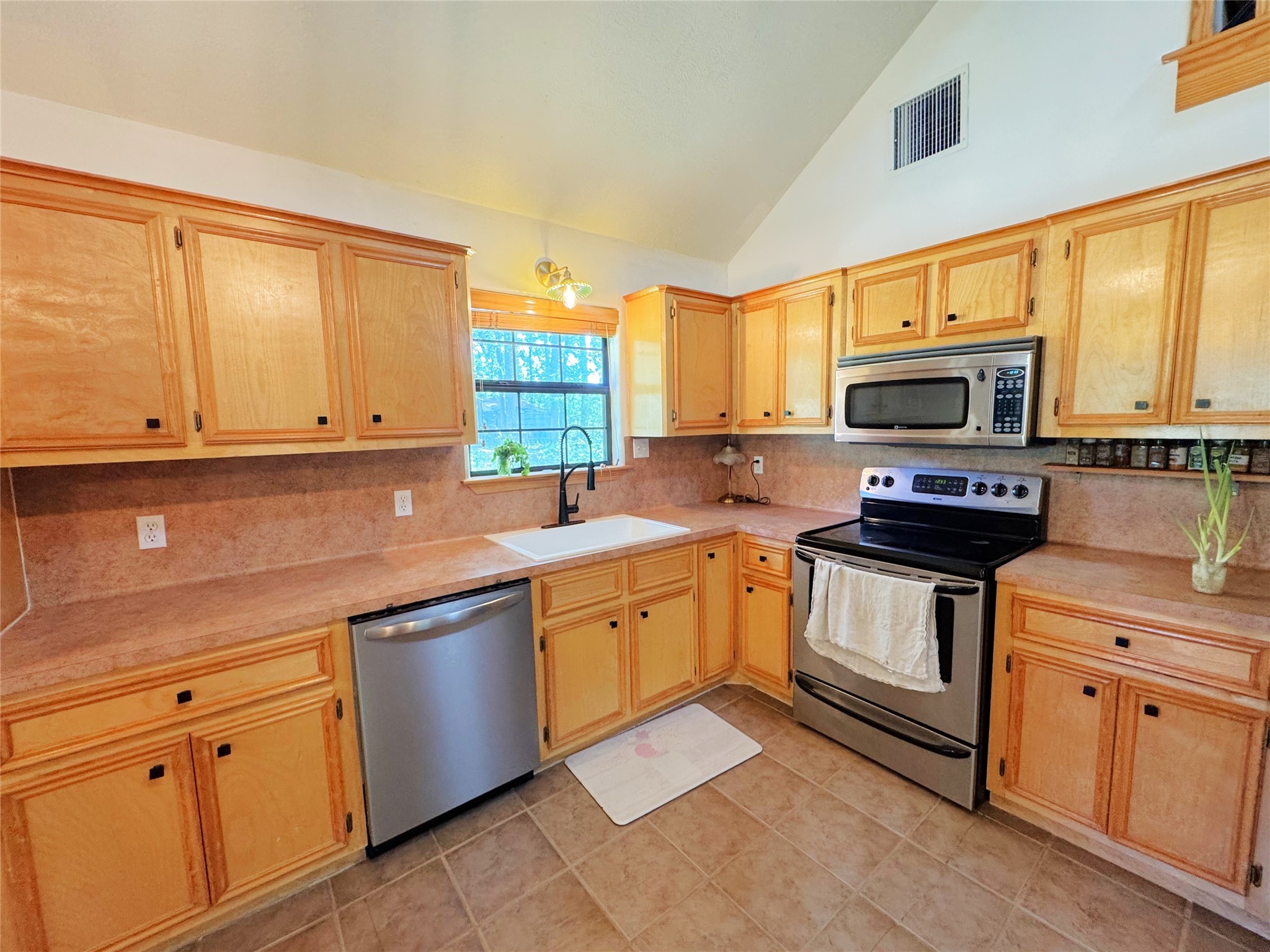 798 Port Boulevard Trinity, TX 75862 - Photo 13 of 31 a kitchen with stainless steel appliances a stove sink and microwave