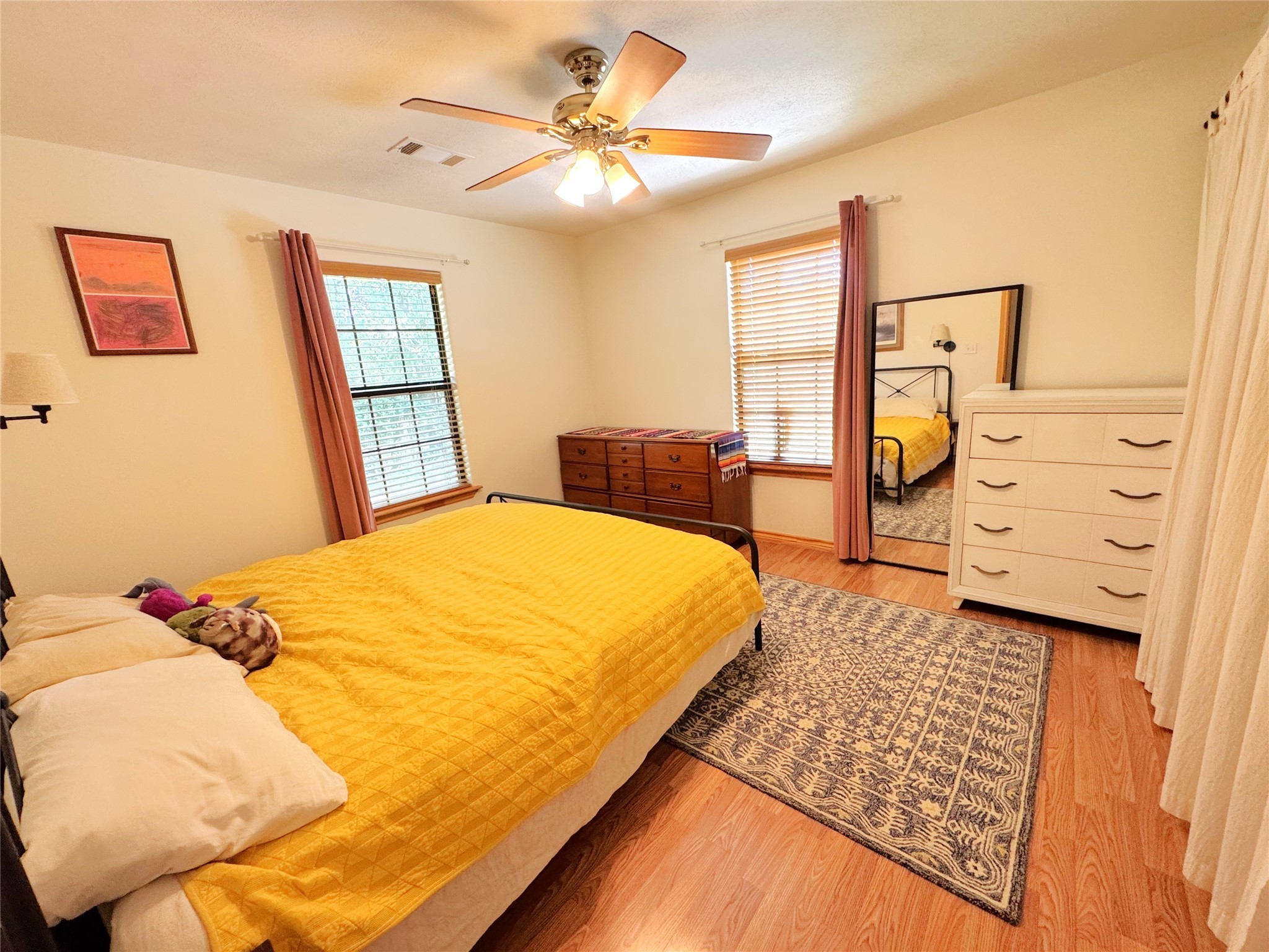 798 Port Boulevard Trinity, TX 75862 - Photo 14 of 31 a bed sitting in a bedroom next to a window
