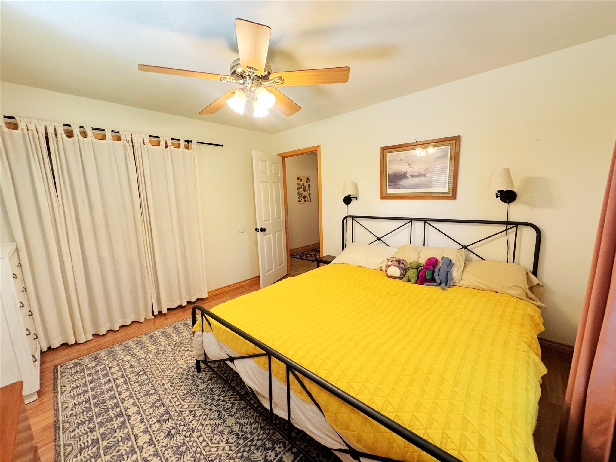 798 Port Boulevard Trinity, TX 75862 - Photo 15 of 31 a bedroom with a bed and a chandelier